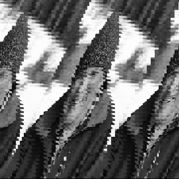 en person med hatt og smilende til kameraet